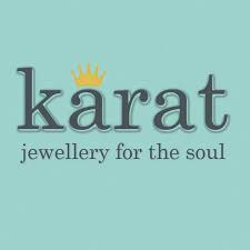 Karat jewelry logo with crown symbol on turquoise background