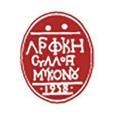 Red oval logo with white Greek text reading "ΑΡΧΗ ΣΥΛΛΟΓ ΜΥΚΟΝΣ" and year 1939